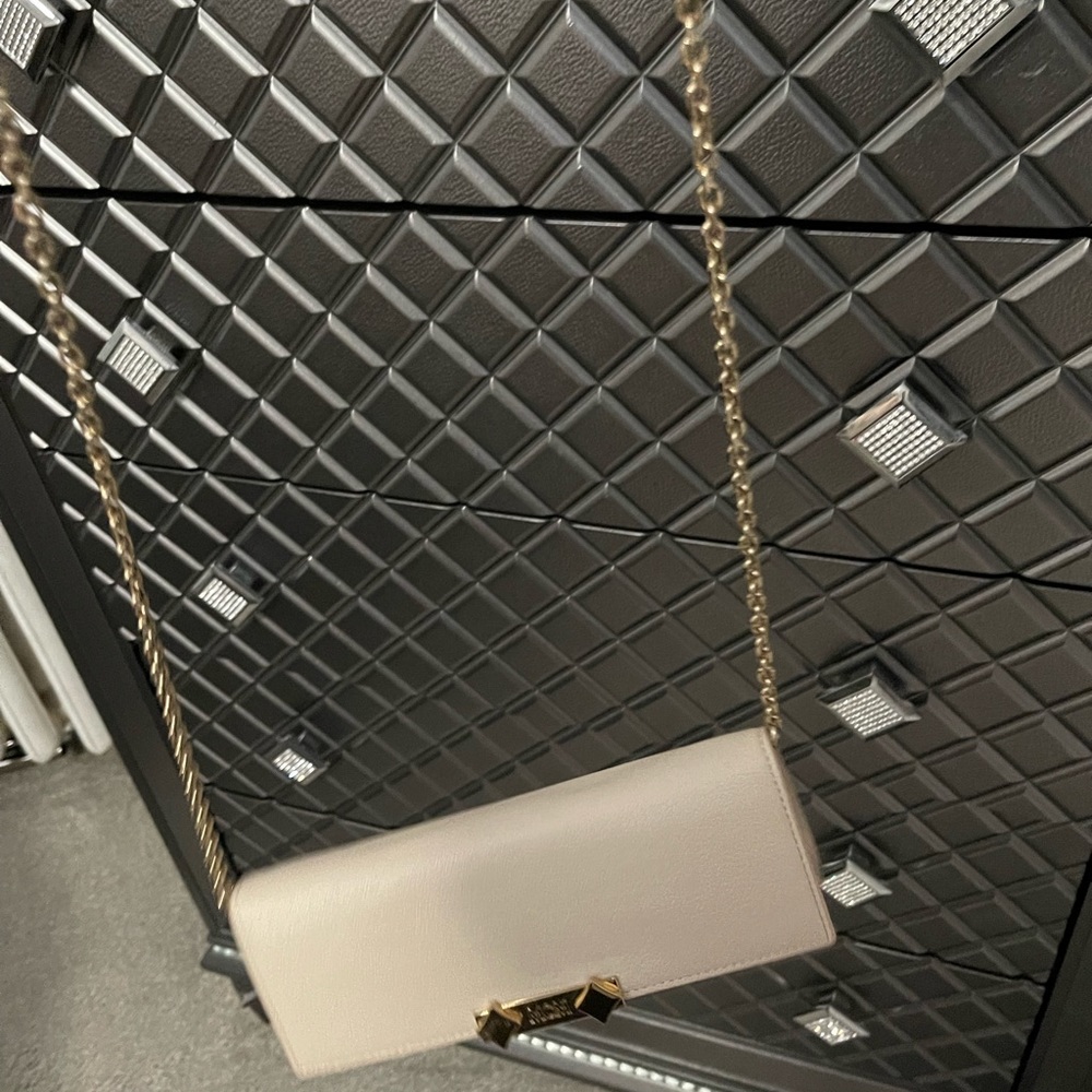 Tan leather McM bag wallet size with gold chain attached.. comes w/box and bag